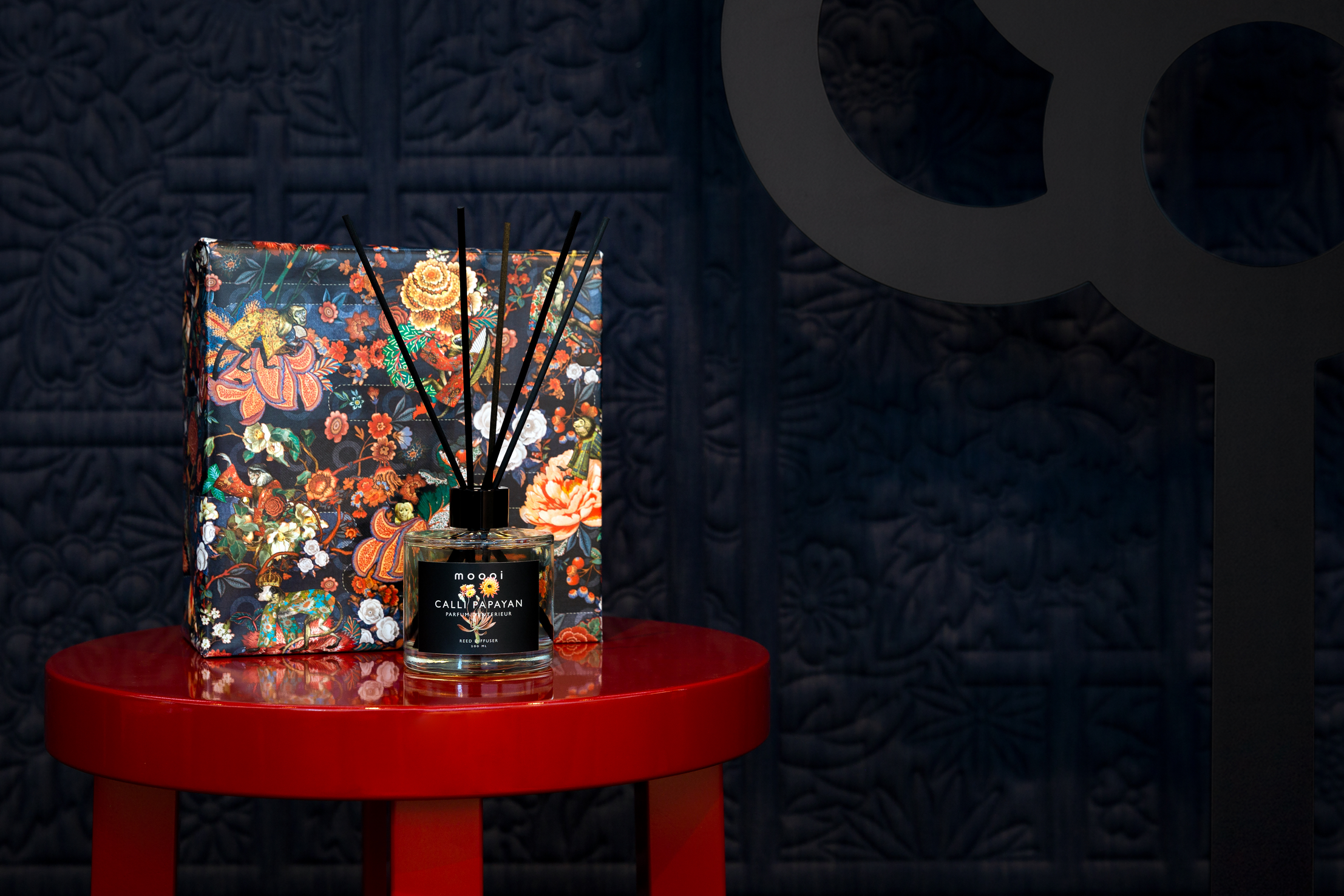 Moooi Giftwrapped box with reed sticks on a common comrades table.